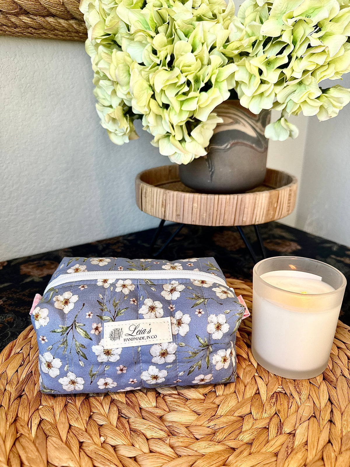 Small blue floral quilted boxy bag with pink gingham lining, white zipper, and Leia’s handmade label