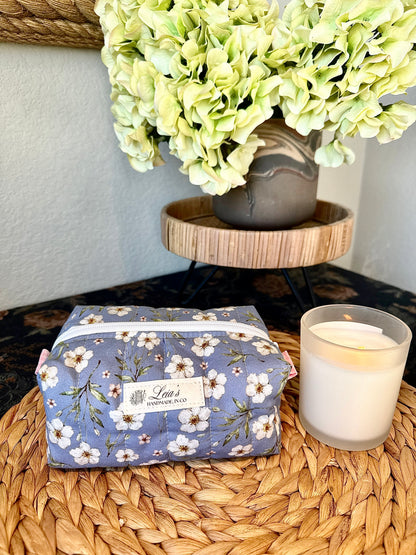 Small blue floral quilted boxy bag with pink gingham lining, white zipper, and Leia’s handmade label