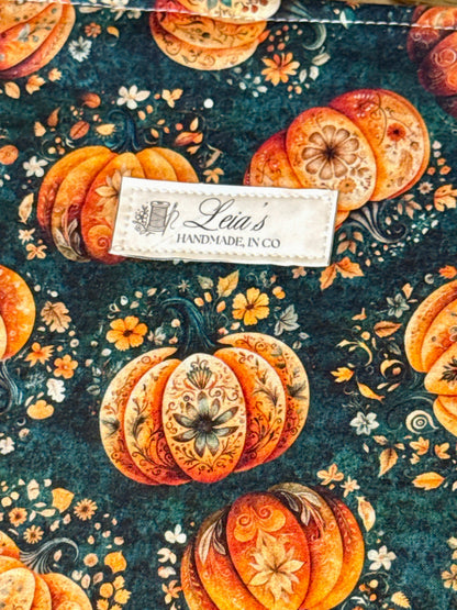Close-up of Leia's Handmade in CO woven label on the Gilded Gourd quilted pumpkin print fabric