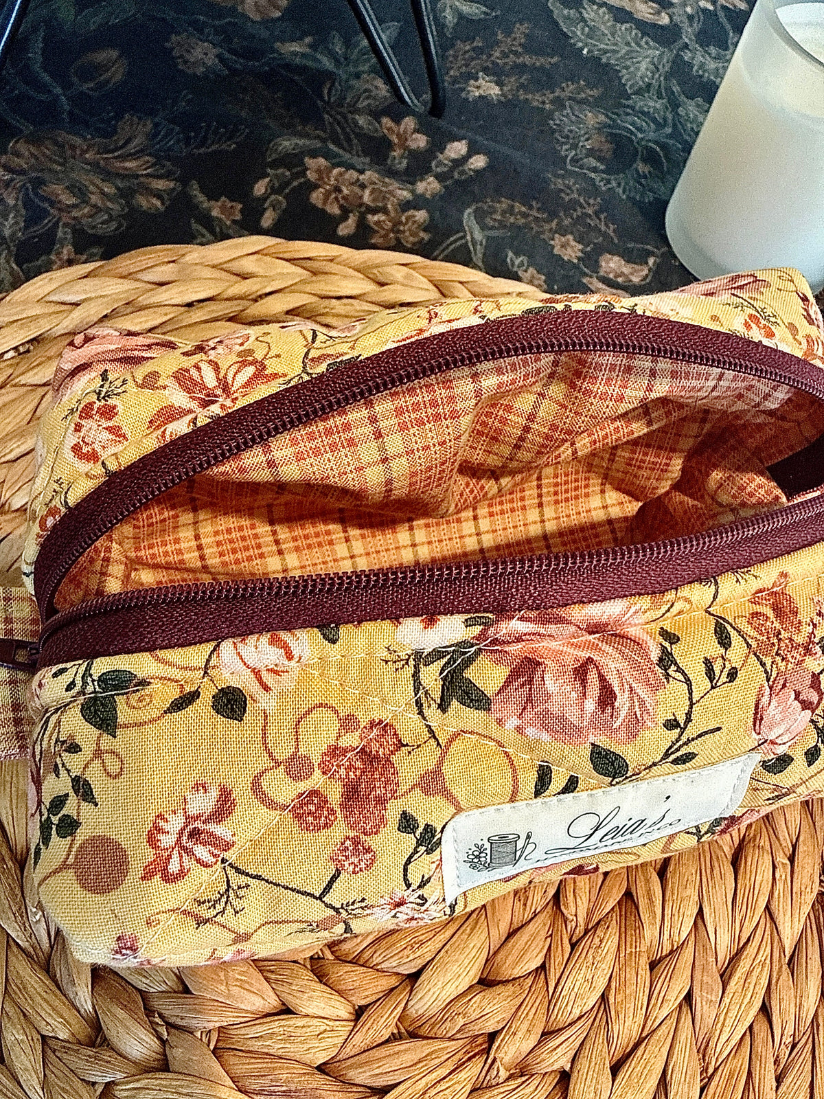 Open Honey Roses boxy bag showing its brown plaid lining, burgundy zipper, and handmade label