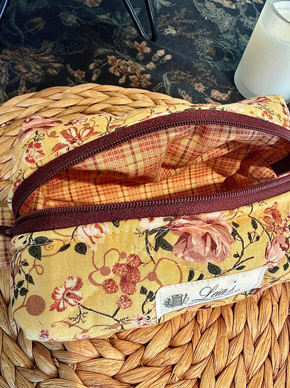Open Honey Roses boxy bag showing its brown plaid lining, burgundy zipper, and handmade label