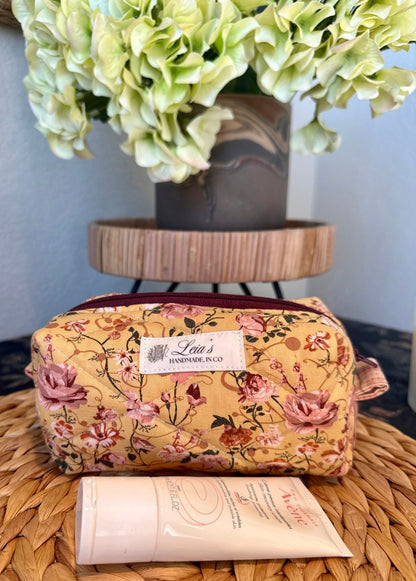 Small golden floral quilted boxy bag with pink roses, Leia’s handmade label, and burgundy zipper