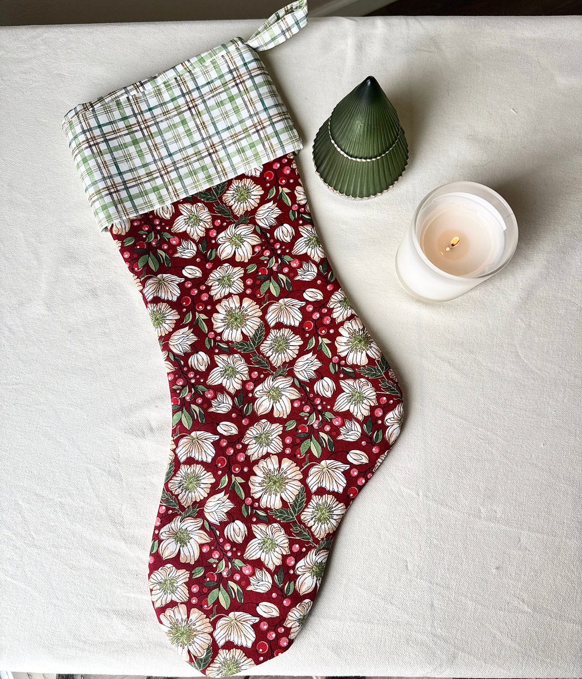 Full-length handmade Berry Blossom Christmas stocking with a burgundy floral body, green-and-cream plaid cuff, and matching hanging loop.
