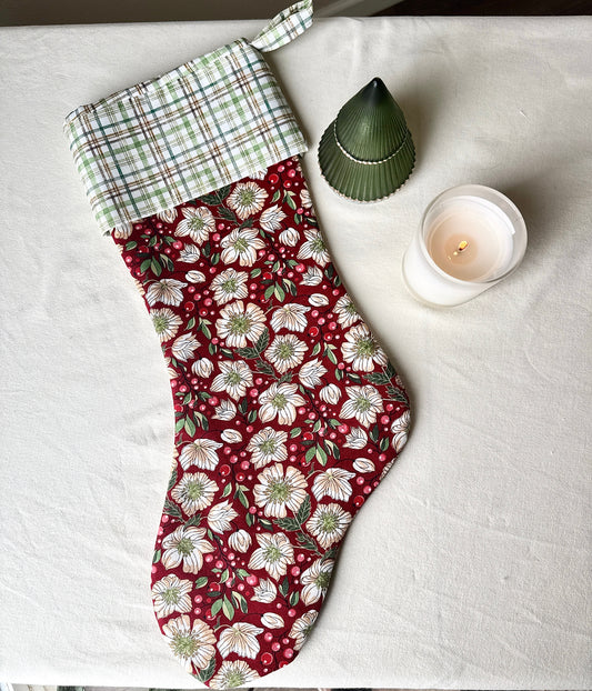 Full-length handmade Berry Blossom Christmas stocking with a burgundy floral body, green-and-cream plaid cuff, and matching hanging loop.