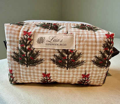 Front view of the small Winter Sprig quilted boxy bag with evergreen and red berry print and Leia’s handmade label