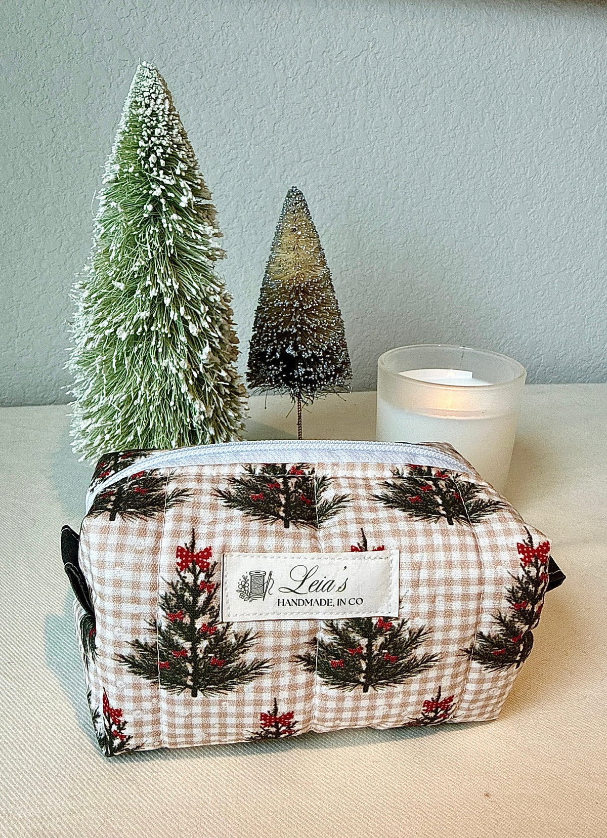 Front view of the bag showing its white zipper and boxy shape