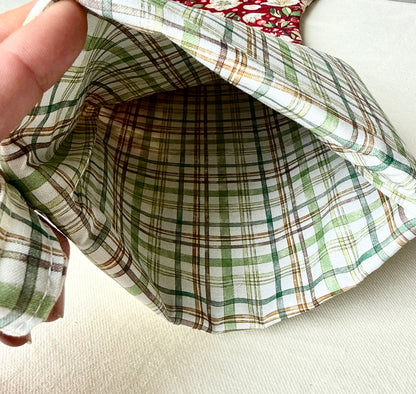 Open Berry Blossom Christmas stocking showing its green-and-cream plaid interior lining and cuff.