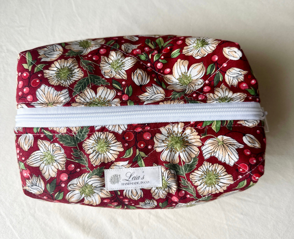 Large handmade Berry Blossom quilted boxy bag viewed from above, showing its burgundy floral print, white zipper, and Leia’s label.
