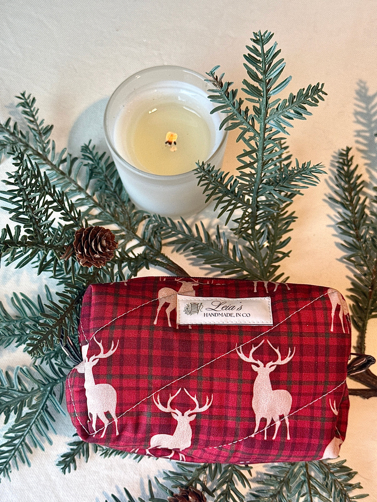 Flat lay view of the small Highland Stag bag showing its quilted exterior, and label