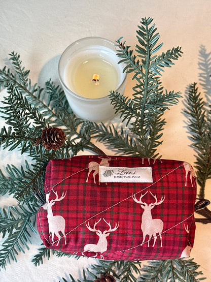 Flat lay view of the small Highland Stag bag showing its quilted exterior, and label