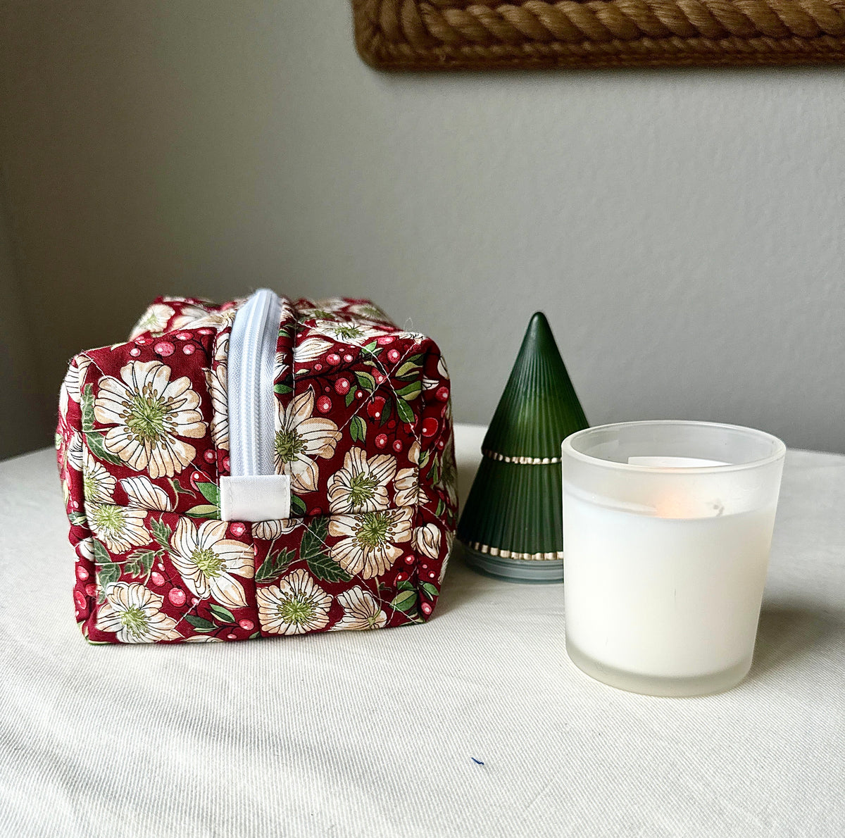 Side view of the large Berry Blossom quilted boxy bag, showing its boxy shape, burgundy floral fabric, and white zipper.