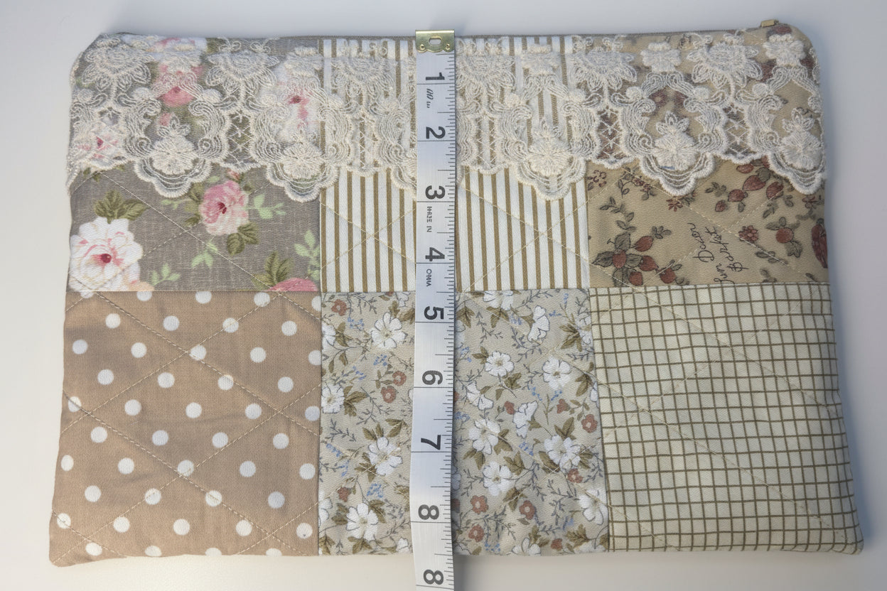 Fabric swatch with various patterns and a ruler for measurement on a white background