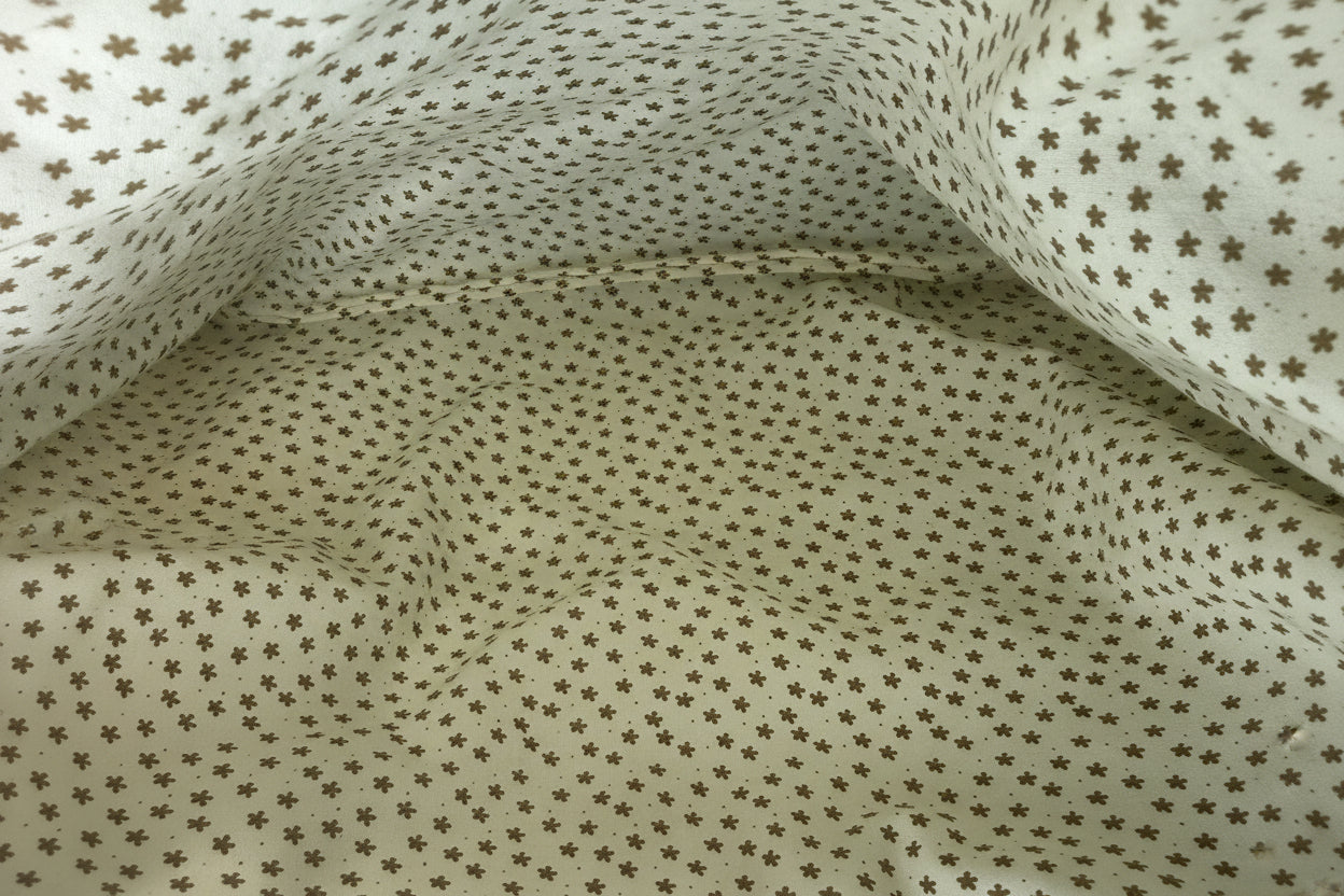 Close-up of liner fabric with small star pattern on a beige background